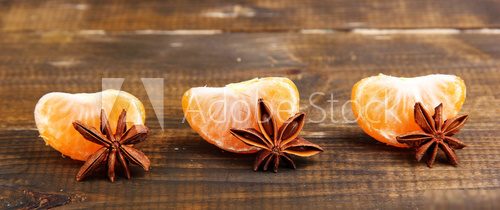 Ripe sweet tangerine, on wooden background,  close-up