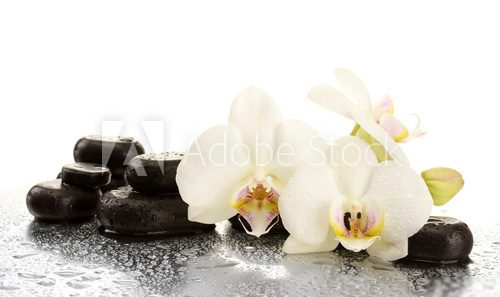 Spa stones and orchid flowers, isolated on white.