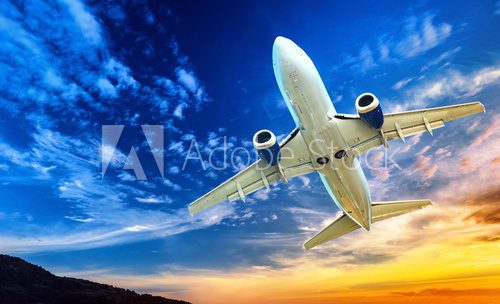 Airplane transportation. Jet air plane flies in blue sky