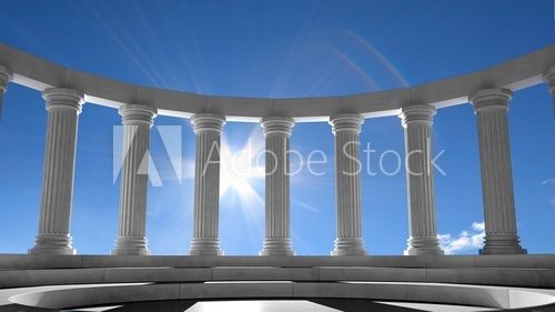 Ancient marble pillars in elliptical arrangement with blue sky