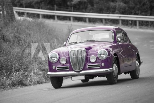 Violet classic car on black and white background