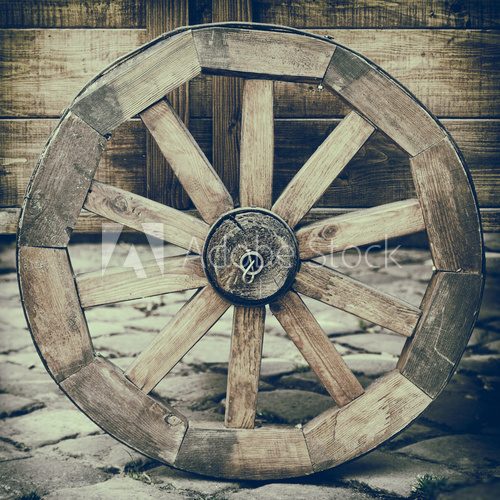 Vintage stylized photo of wooden cart wheel
