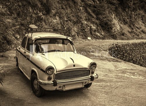 Vintage style photo of retro car parked at nature