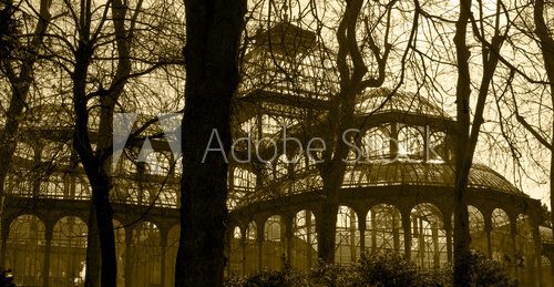 Antique glass building with trees in sepia tone