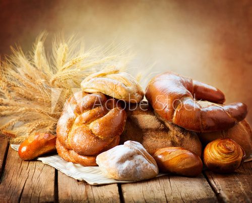Bakery Bread on a Wooden Table. Various Bread and Sheaf