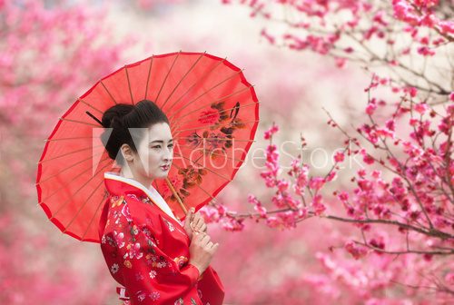 Asian style portrait of a woman with red umbrella