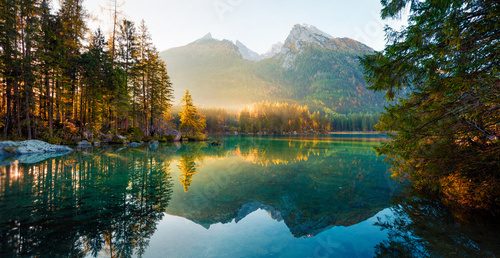 Аabulous autumn sunrise of Hintersee lake. Amazing morning view of Bavarian Alps on the Austrian border, Germany, Europe. Beauty of nature concept background.