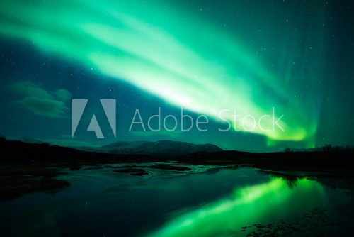 Northern lights above lagoon in Iceland