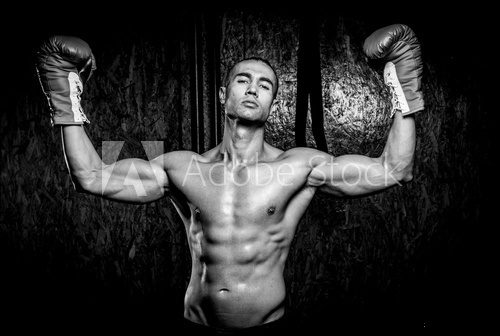 Young muscular man in gym
