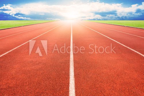 Running track over blue sky and clouds