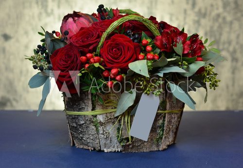 Bouquet of red roses in a box of birch bark