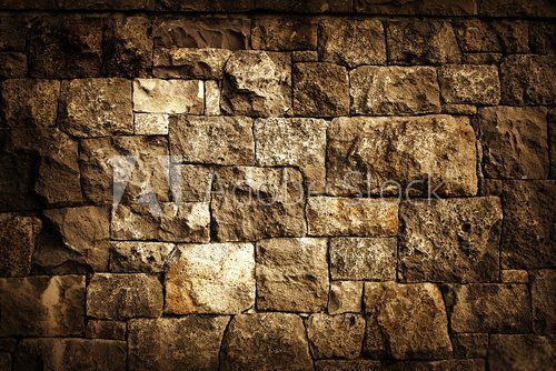 Rough brown rock block wall background