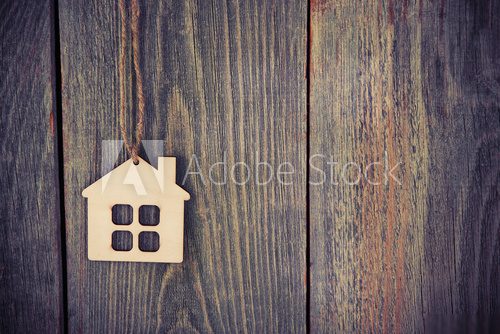 house as symbol on wooden background