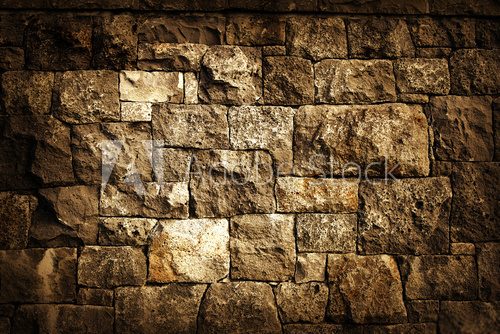 Rough brown rock block wall background