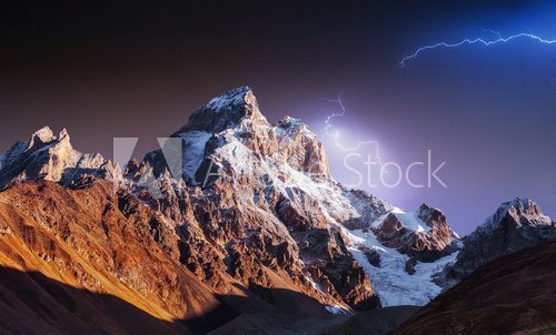 Fantastic collage. Beautiful lightning over the snow-capped moun